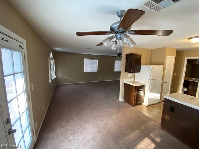 interior space with ceiling fan