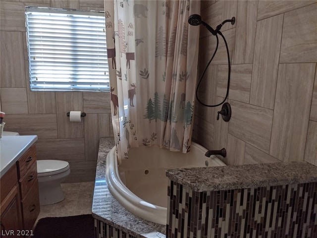 full bathroom featuring toilet, shower / bathtub combination with curtain, vanity, tile walls, and tile floors