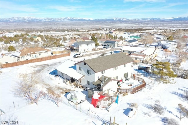 snowy aerial view with a mountain view