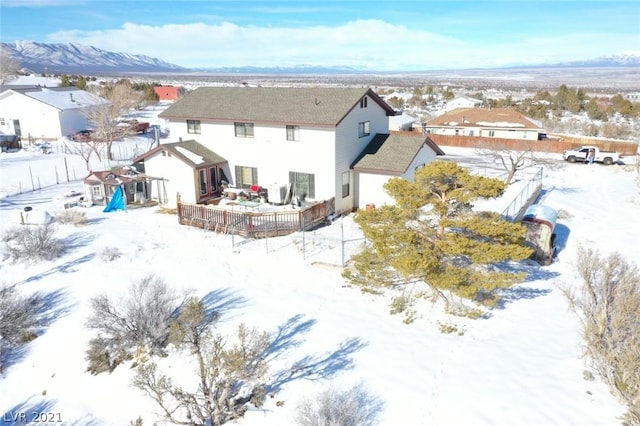 snowy aerial view with a mountain view