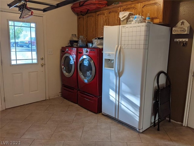 washroom with cabinets, light tile floors, and independent washer and dryer