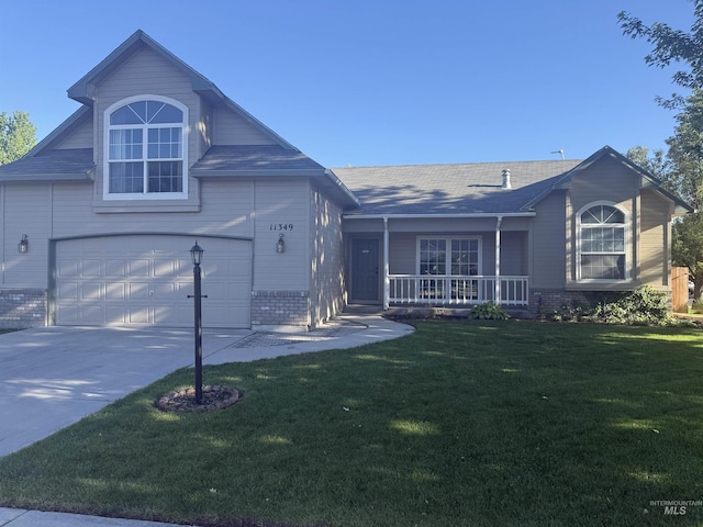 11349 W Marlinwood St, Boise, ID 83713 - view of front of home with brick siding, covered porch, concrete driveway, a front yard, and a garage