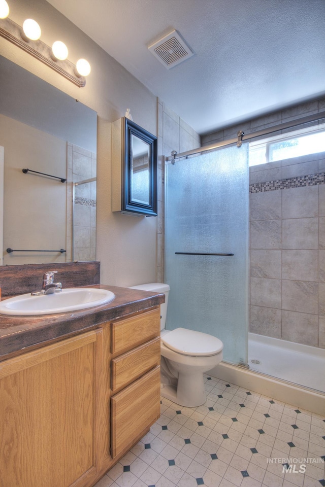 11349 W Marlinwood St, Boise, ID 83713 - bathroom featuring a shower stall, vanity, and tile patterned flooring