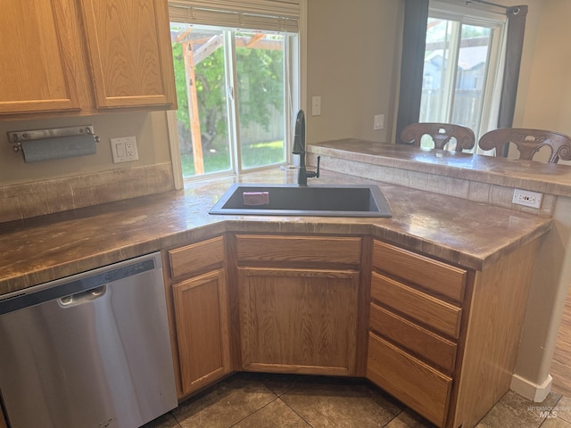 11349 W Marlinwood St, Boise, ID 83713 - kitchen with stainless steel dishwasher, healthy amount of natural light, and dark tile patterned floors