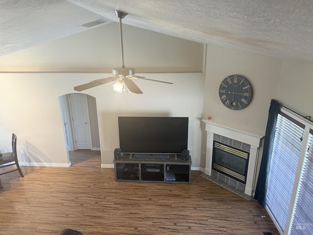 11349 W Marlinwood St, Boise, ID 83713 - unfurnished living room with wood finished floors, a textured ceiling, a ceiling fan, a tile fireplace, and lofted ceiling