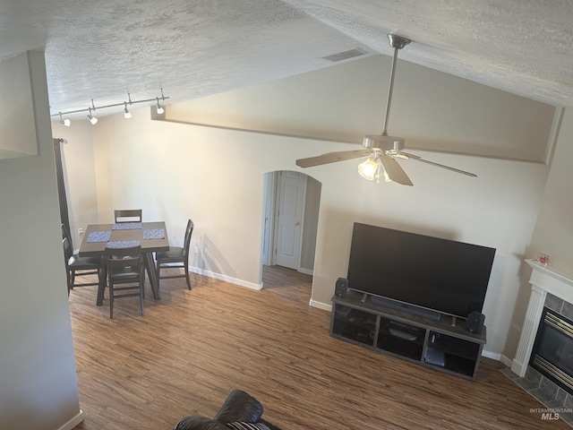 11349 W Marlinwood St, Boise, ID 83713 - living area featuring wood finished floors, ceiling fan, a tile fireplace, a textured ceiling, and lofted ceiling