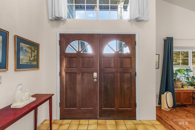 foyer featuring light hardwood / wood-style floors and lofted ceiling