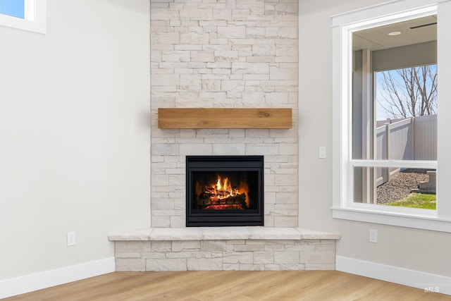 1351 E Andes Dr, Kuna, ID 83634 - detailed view of a stone fireplace, wood finished floors, and baseboards