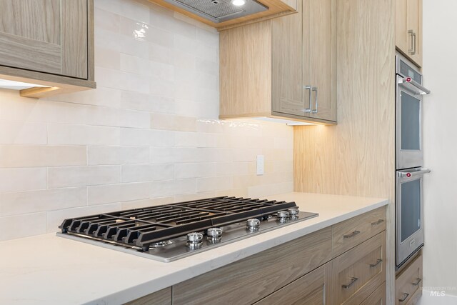 1351 E Andes Dr, Kuna, ID 83634 - kitchen with appliances with stainless steel finishes, light countertops, and decorative backsplash