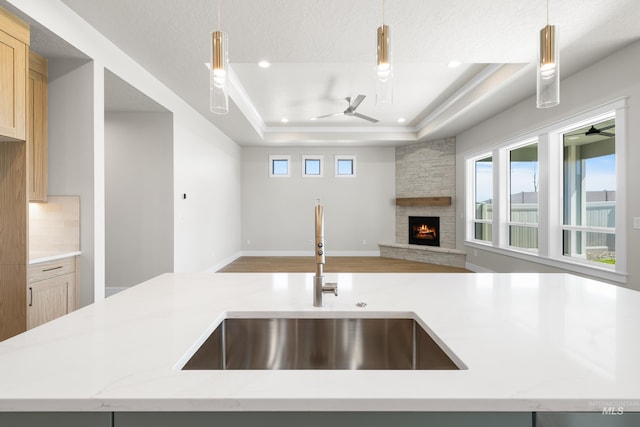 1351 E Andes Dr, Kuna, ID 83634 - kitchen featuring a sink, a ceiling fan, open floor plan, a stone fireplace, and recessed lighting