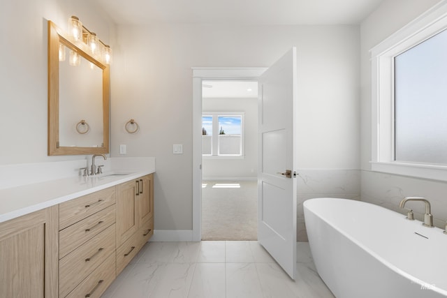 1351 E Andes Dr, Kuna, ID 83634 - bathroom with a soaking tub, vanity, marble finish flooring, and baseboards