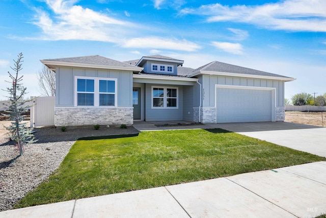 1351 E Andes Dr, Kuna, ID 83634 - prairie-style home with stone siding, an attached garage, driveway, board and batten siding, and roof with shingles