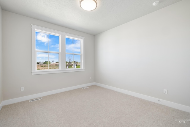 1351 E Andes Dr, Kuna, ID 83634 - carpeted spare room featuring baseboards, a smoke detector, and a textured ceiling