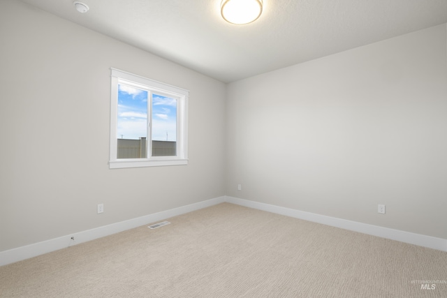 1351 E Andes Dr, Kuna, ID 83634 - spare room with light carpet, baseboards, and a smoke detector