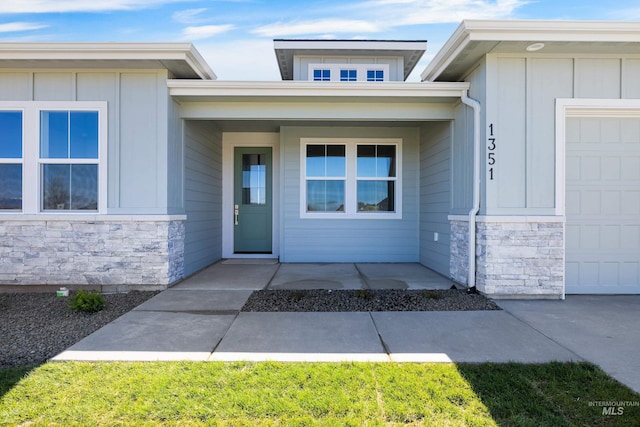 1351 E Andes Dr, Kuna, ID 83634 - doorway to property with stone siding, board and batten siding, and an attached garage