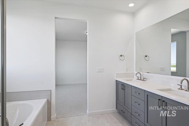 5509 N Patimos Ave, Meridian, ID 83646 - bathroom with double vanity, a sink, baseboards, and a bath