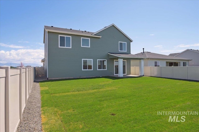 5509 N Patimos Ave, Meridian, ID 83646 - rear view of house with a fenced backyard and a yard