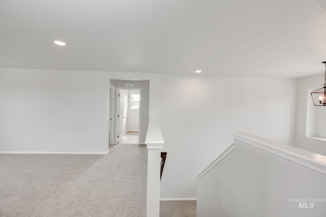 interior space featuring carpet flooring and an inviting chandelier