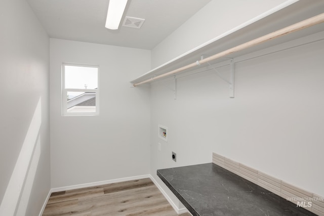 laundry room featuring hookup for an electric dryer, hookup for a washing machine, and light hardwood / wood-style flooring