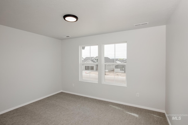 unfurnished room featuring carpet