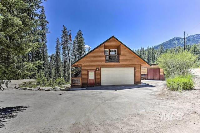 exterior space with a mountain view and a garage