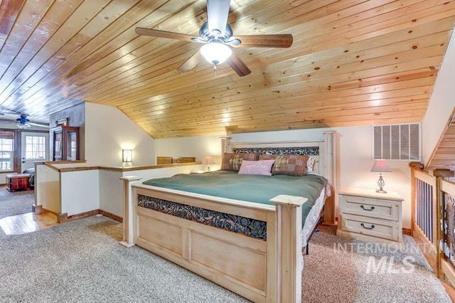 bedroom with light colored carpet, lofted ceiling, wood ceiling, and baseboards