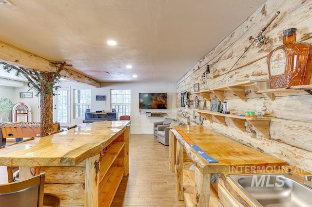 kitchen with a sink, light wood-style flooring, open floor plan, and recessed lighting