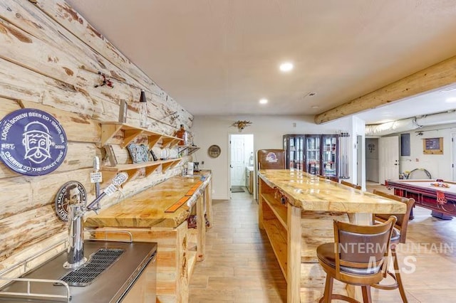 kitchen featuring a kitchen breakfast bar, pool table, recessed lighting, light wood finished floors, and a center island