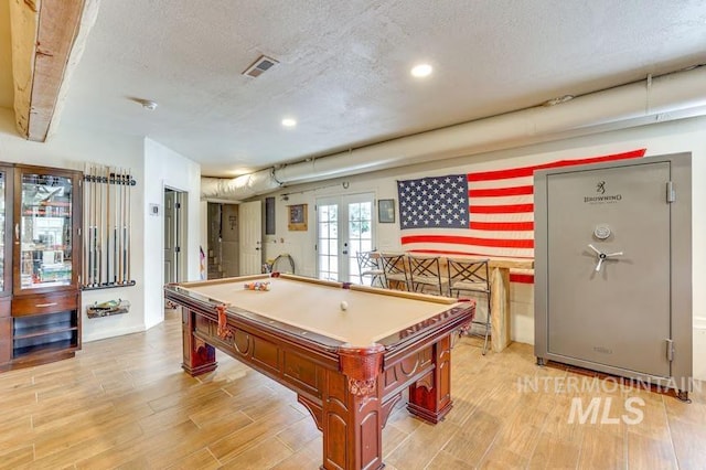 playroom featuring french doors, pool table, a textured ceiling, light wood-style floors, and recessed lighting
