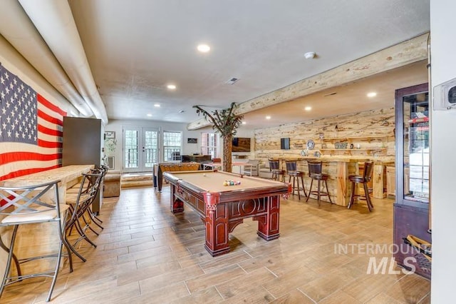 game room featuring pool table, a bar, recessed lighting, and wood finished floors