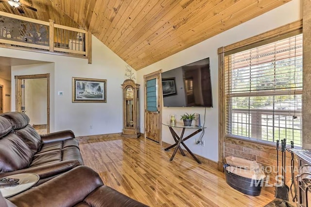 living room with wood finished floors, high vaulted ceiling, wooden ceiling, ceiling fan, and baseboards
