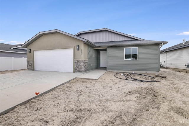 single story home with a garage, fence, and driveway