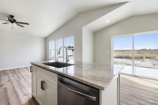 kitchen with a sink, white cabinetry, dishwasher, and vaulted ceiling