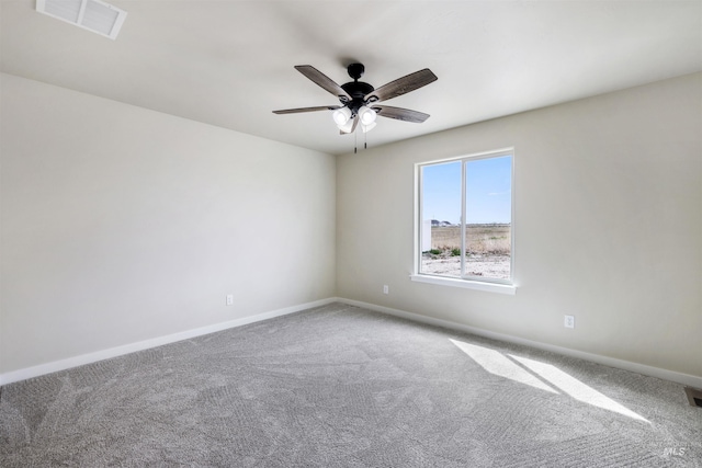 unfurnished room with visible vents, carpet flooring, baseboards, and ceiling fan