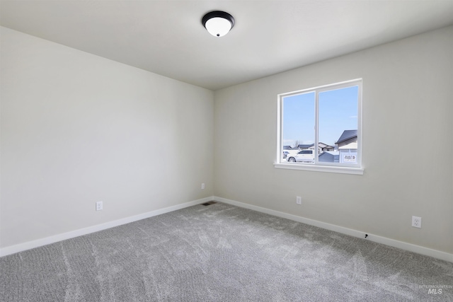 unfurnished room featuring baseboards, carpet flooring, and visible vents