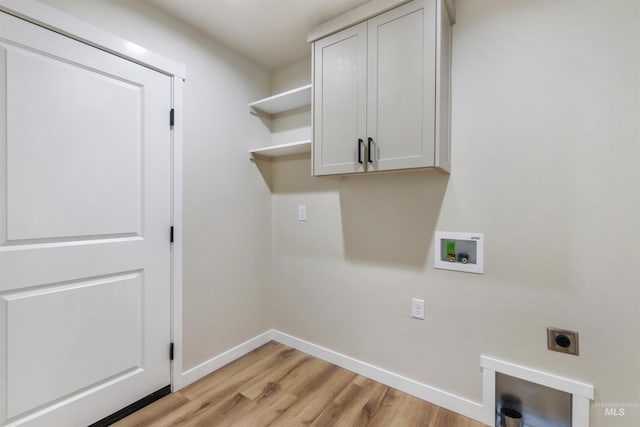washroom featuring cabinet space, washer hookup, light wood-style flooring, electric dryer hookup, and baseboards