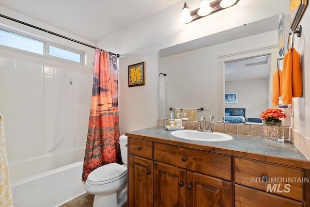 full bathroom with shower / bathtub combination with curtain, vanity, and toilet