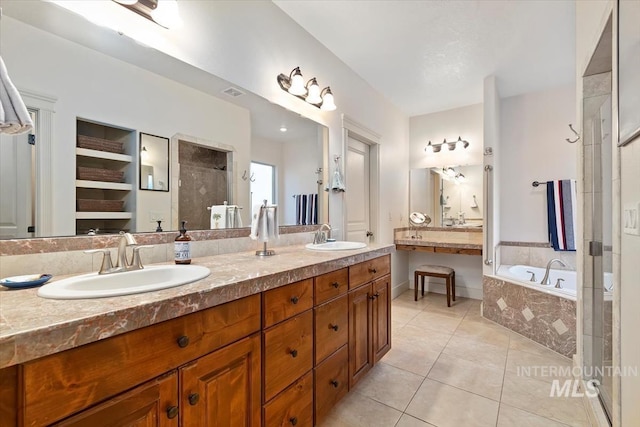 bathroom with shower with separate bathtub, vanity, and tile patterned floors