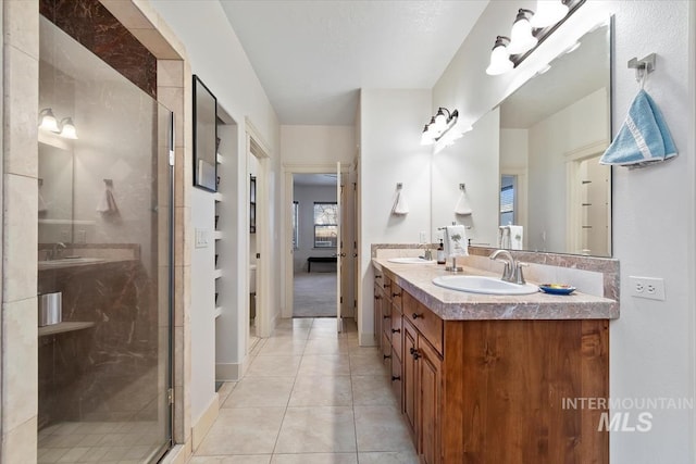 bathroom with tile patterned flooring, vanity, and a shower with shower door