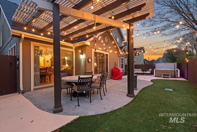 patio terrace at dusk featuring a pergola and a hot tub