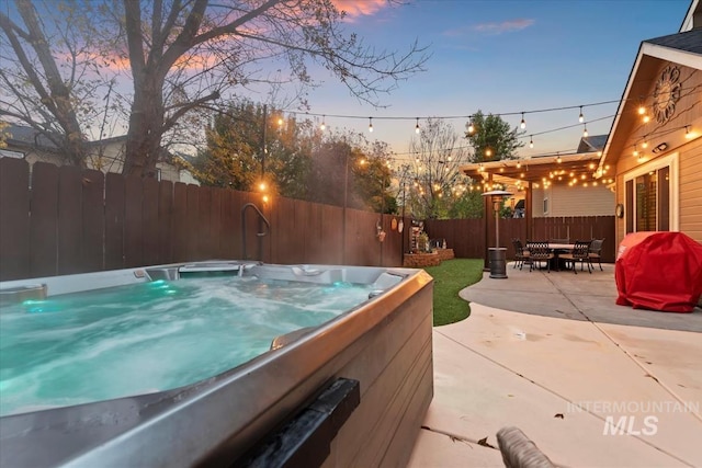 exterior space featuring area for grilling and a hot tub