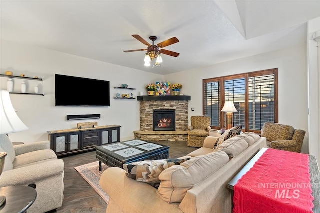 living room featuring a fireplace and ceiling fan