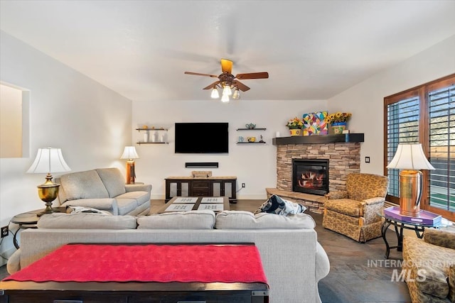 living room featuring a fireplace, hardwood / wood-style floors, and ceiling fan