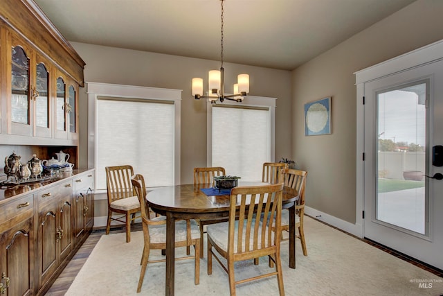 dining area featuring a chandelier and light wood-type flooring