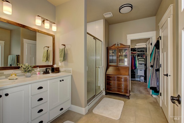 bathroom with vanity, walk in shower, and tile patterned floors