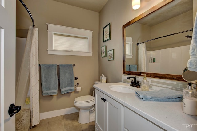 bathroom featuring tile patterned floors, toilet, a healthy amount of sunlight, curtained shower, and vanity