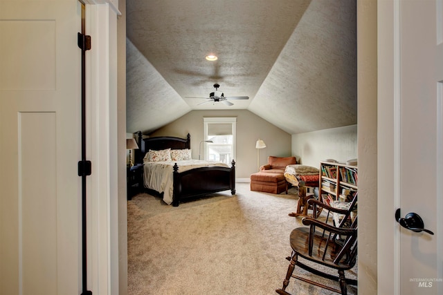 bedroom featuring vaulted ceiling, a textured ceiling, carpet floors, and ceiling fan