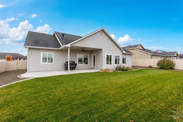 rear view of house with a patio area, a lawn, and ceiling fan