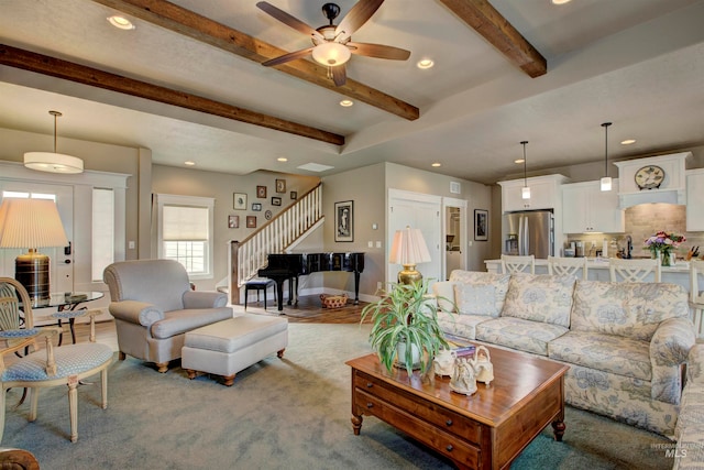 carpeted living room with beam ceiling and ceiling fan