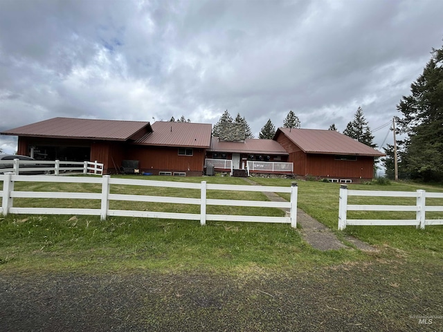 170 Red Fir Rd, Kooskia, ID 83539 - view of front of home with metal roof, an outdoor structure, an exterior structure, an attached garage, and driveway
